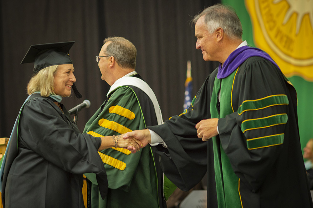 A Siena graduate shakes hands during a graduation ceremony